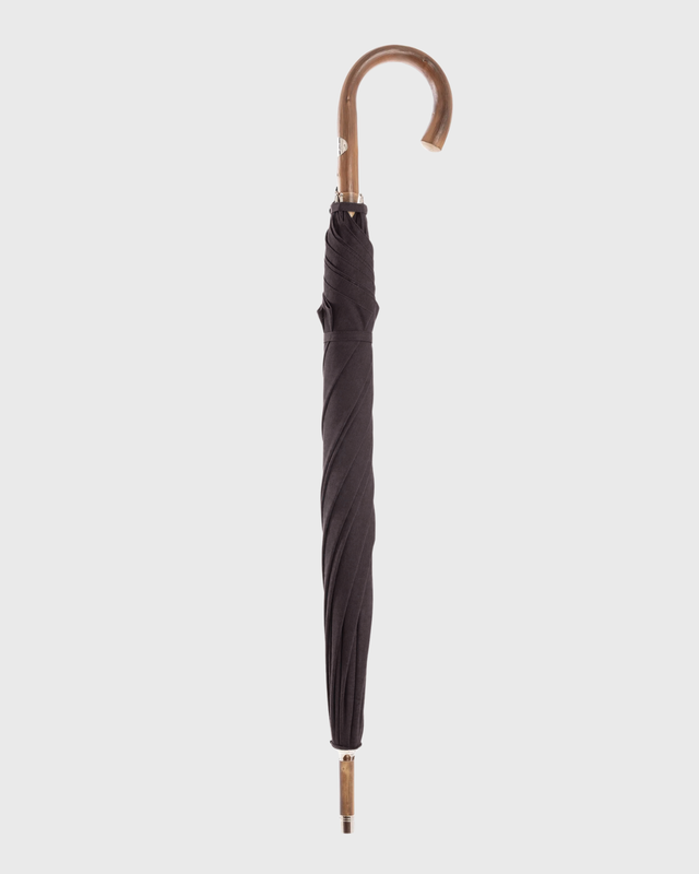 A closed dark brown umbrella with a curved wooden handle, shown vertically against a light gray background.