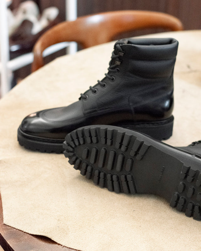 John Lobb Peak boot in black calf and light grain, styled view showing the sole